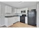 Well-lit kitchen with white cabinets, black appliances, and modern finishes at 944 Joseph E Boone Nw Blvd, Atlanta, GA 30314