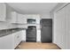 Well-lit kitchen with white cabinets, black appliances, and modern finishes at 944 Joseph E Boone Nw Blvd, Atlanta, GA 30314