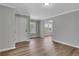 Open-concept living and dining area with wood floors, gray walls, and large windows at 944 Joseph E Boone Nw Blvd, Atlanta, GA 30314