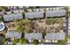 Aerial view showcases the layout of the townhouse community with mature trees and manicured landscaping at 11265 Musette Cir, Alpharetta, GA 30009