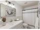 Bathroom featuring a vanity with a sink, toilet, and shower with a stylish curtain at 11265 Musette Cir, Alpharetta, GA 30009