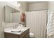Bathroom with a single vanity, shower with curtain, and minimalist decor creating a serene atmosphere at 11265 Musette Cir, Alpharetta, GA 30009