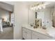 Bathroom with double sinks, sleek lighting, and a view into the bedroom, combining style and functionality at 11265 Musette Cir, Alpharetta, GA 30009
