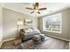 Inviting bedroom featuring a cozy daybed, accent pillows, and a large window with bright natural light at 11265 Musette Cir, Alpharetta, GA 30009