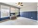 Bonus room featuring custom wall trim, built-in shelving, and windows providing natural light at 11265 Musette Cir, Alpharetta, GA 30009