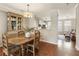 Dining room with rustic wood table and china cabinet, adjacent to the kitchen at 11265 Musette Cir, Alpharetta, GA 30009