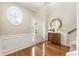 Foyer featuring a hardwood floor, an oval window, and elegant decor, creating an inviting entrance at 11265 Musette Cir, Alpharetta, GA 30009