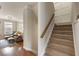 Bright foyer with hardwood floors, staircase, and a glimpse of the living room creates a warm and inviting entrance at 11265 Musette Cir, Alpharetta, GA 30009