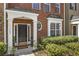Classic brick front entrance featuring white columns and manicured greenery at 11265 Musette Cir, Alpharetta, GA 30009