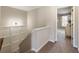 Upstairs hallway showcases wainscoting and leads to a bedroom, offering a bright and inviting transition space at 11265 Musette Cir, Alpharetta, GA 30009