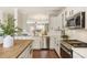 Bright kitchen with white cabinets, stainless steel appliances, and a butcher block island at 11265 Musette Cir, Alpharetta, GA 30009