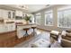 Bright kitchen featuring white cabinets, butcher block island, and natural light at 11265 Musette Cir, Alpharetta, GA 30009