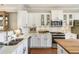 Modern kitchen featuring white cabinetry, stainless steel appliances, and quartz countertops at 11265 Musette Cir, Alpharetta, GA 30009