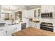 Beautiful kitchen with stainless steel appliances, subway tile backsplash, and white cabinetry at 11265 Musette Cir, Alpharetta, GA 30009