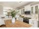 Modern kitchen featuring white cabinets, granite countertops, and stainless steel appliances at 11265 Musette Cir, Alpharetta, GA 30009