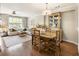 Open-concept dining and living area with hardwood floors, neutral colors, and natural light at 11265 Musette Cir, Alpharetta, GA 30009