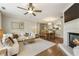 Comfortable living room with fireplace, sofa, and view of the dining area at 11265 Musette Cir, Alpharetta, GA 30009