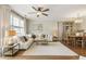 Bright living room with a large window, stylish decor, and hardwood floors at 11265 Musette Cir, Alpharetta, GA 30009