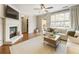 Spacious living room with fireplace, large windows, and access to the balcony at 11265 Musette Cir, Alpharetta, GA 30009