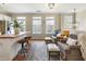 Cozy living room with hardwood floors, natural light, and a view of the updated kitchen at 11265 Musette Cir, Alpharetta, GA 30009