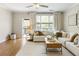 Inviting living room with neutral tones and a cozy seating arrangement at 11265 Musette Cir, Alpharetta, GA 30009