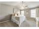 Serene main bedroom with vaulted ceiling, neutral tones, ample natural light, and a comfortable queen-sized bed at 11265 Musette Cir, Alpharetta, GA 30009