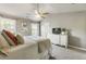 Comfortable main bedroom features a vaulted ceiling, neutral colors, plentiful natural light, and stylish furnishings at 11265 Musette Cir, Alpharetta, GA 30009