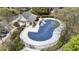 Aerial view of the community pool, with lounge chairs, a clubhouse, and a security fence at 11265 Musette Cir, Alpharetta, GA 30009