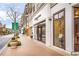 Boutique retail stores line the street in a walkable, landscaped outdoor shopping district at 11265 Musette Cir, Alpharetta, GA 30009