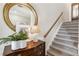 Close up of an entryway staircase with wood accents and stylish decor at 11265 Musette Cir, Alpharetta, GA 30009