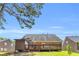 Spacious backyard featuring a well-maintained lawn and deck, ideal for outdoor living and recreation at 1211 Liverpool Pointe, Lawrenceville, GA 30046