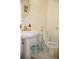 Simple bathroom featuring a pedestal sink and toilet, with white tile flooring at 1211 Liverpool Pointe, Lawrenceville, GA 30046