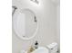 Clean bathroom featuring single sink, gold faucet, and oval mirror at 1211 Liverpool Pointe, Lawrenceville, GA 30046