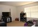 Bedroom with a TV, storage shelves, and a comfortable seating area, perfect for relaxation and entertainment at 1211 Liverpool Pointe, Lawrenceville, GA 30046