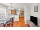 Open dining room with hardwood floors next to a kitchen with stainless steel appliances and wooden cabinets at 1211 Liverpool Pointe, Lawrenceville, GA 30046