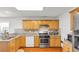 Functional kitchen features stainless steel appliances, wood cabinets, and a granite countertop at 1211 Liverpool Pointe, Lawrenceville, GA 30046