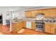 Functional kitchen features stainless steel appliances, wood cabinets, and a granite countertop at 1211 Liverpool Pointe, Lawrenceville, GA 30046