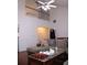 Open living room with a high ceiling, ceiling fan, and a view of the upper level at 1211 Liverpool Pointe, Lawrenceville, GA 30046