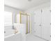 Elegant main bathroom features a soaking tub, a separate shower, and neutral tile flooring at 1211 Liverpool Pointe, Lawrenceville, GA 30046
