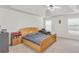 Spacious main bedroom featuring plush carpet, a tray ceiling with fan, and large windows at 1211 Liverpool Pointe, Lawrenceville, GA 30046
