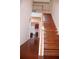 Elegant staircase with wooden banister leading to the second floor, showcasing hardwood floors at 1211 Liverpool Pointe, Lawrenceville, GA 30046