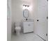 Bathroom featuring a toilet, a single vanity with a black faucet, and a round black mirror at 2863 Landing Dr, Marietta, GA 30066