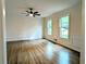 Spacious living room featuring hardwood floors, detailed trim, and natural light from two large windows at 2863 Landing Dr, Marietta, GA 30066