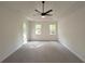 Bright main bedroom featuring neutral carpet, tray ceilings, and natural light at 2863 Landing Dr, Marietta, GA 30066