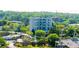 Aerial view of the residential building surrounded by green trees and a neighborhood at 587 Virginia Ne Ave # 314, Atlanta, GA 30306
