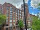 Exterior view of a historic brick building featuring large windows and architectural details at 587 Virginia Ne Ave # 314, Atlanta, GA 30306