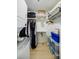 Functional closet space with built-in shelving, hanging rods, and stacked washer/dryer for optimal organization at 587 Virginia Ne Ave # 314, Atlanta, GA 30306