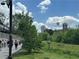 Scenic community pathway with lush greenery, landscaping, and views of nearby buildings on a sunny day at 587 Virginia Ne Ave # 314, Atlanta, GA 30306