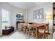 Bright dining room with modern lighting, art and wood table with seating for six at 587 Virginia Ne Ave # 314, Atlanta, GA 30306
