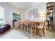 Light-filled dining room with modern art, wood table, chairs, and bookcase at 587 Virginia Ne Ave # 314, Atlanta, GA 30306